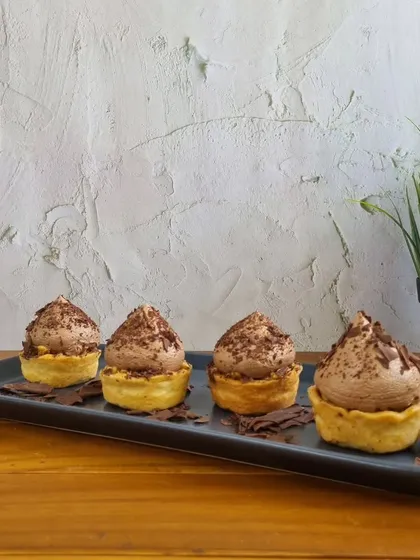 For those who love individual desserts, I offer these chocolate mousse tarts. They have a buttery tart shell filled with airy, rich chocolate mousse and topped with delicate chocolate shavings.