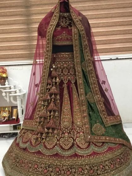 This rental is a gorgeous maroon and green velvet lehenga. The dual-tone dupatta and rich embroidery make it a unique and royal option for your special day.