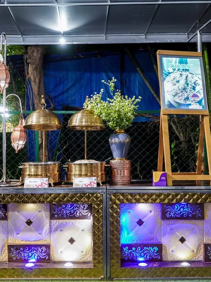 A view of our buffet setup, featuring our signature brass serving dishes and a framed menu to inform guests of the delicious options.