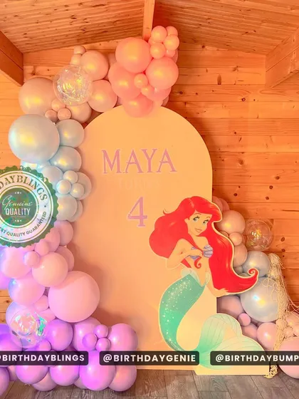 This Little Mermaid theme uses a simple arched backdrop and a beautiful pastel balloon garland. The life-sized Ariel cutout is the star of the show.