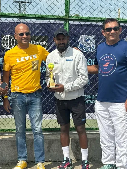 Receiving the singles champion trophy at the ITF MT200 tournament.