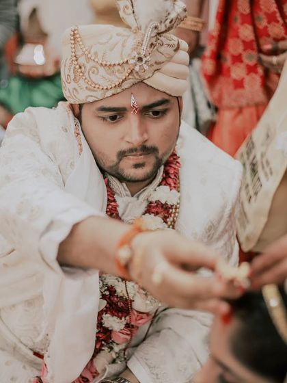 A candid shot of the groom performing a ritual during the wedding ceremony. I focus on capturing these moments of devotion and tradition with authenticity.
