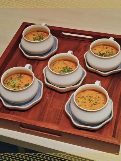 A tray of warm, comforting soup served in stylish two-piece bowls. A perfect starter for a formal dinner, our soups are crafted to warm the soul.