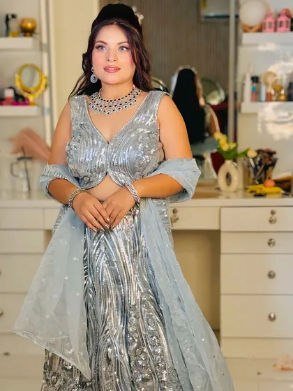 Dazzle at your next cocktail party or reception in this stunning silver sequin lehenga. The all-over sparkle and modern design make it a true showstopper, available for rent for your special night.