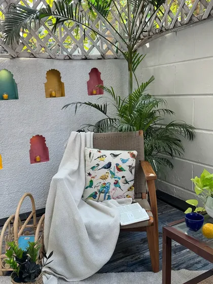 The same armchair frame as before, but styled differently. This shows how versatile a good chair design can be. With a different cushion and throw, it takes on a completely new personality.
