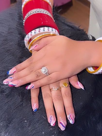 A colorful and festive design perfect for Indian wedding functions, with abstract swirls of pink and blue on a natural base.