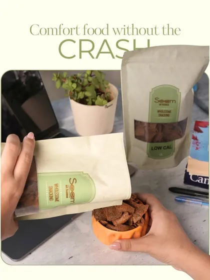 A person enjoying my low-calorie snacks at their work desk. It's comfort snacking that works as hard as you do, made with clean, real ingredients.