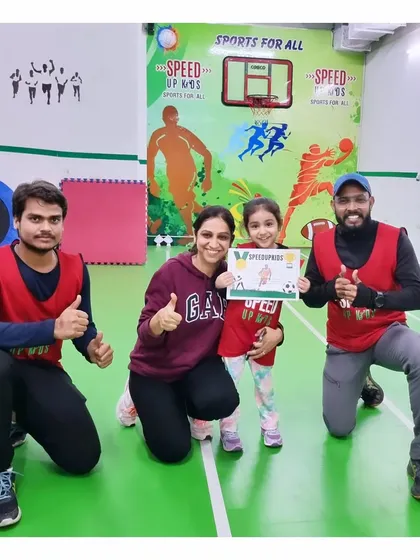 Nyra, our 'Most Valuable Kid' for February, posing with her mom and coaches. Her hard work over the past six months has been amazing.