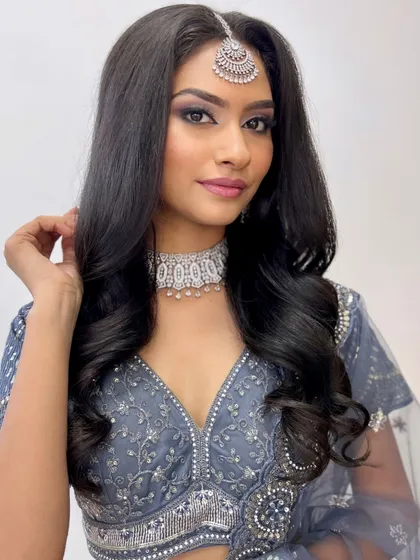 A classic silver and black smokey eye paired with a nude pink lip. This is a timeless reception look that you will master.