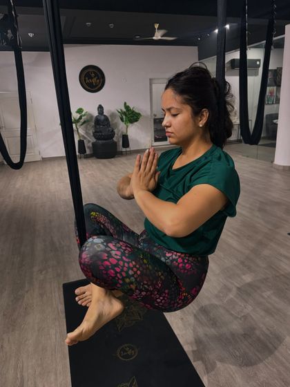 A moment of peace and focus. This student finds her center while seated in the hammock, demonstrating the meditative aspect of our practice.