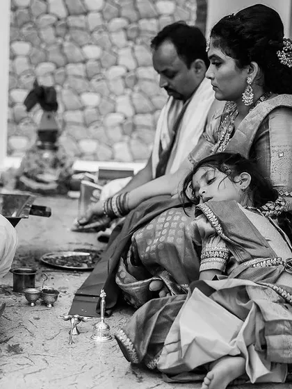 Sometimes the most powerful moments are the quietest ones. This little one falling asleep on her mother's lap during a long ceremony is a real, unfiltered memory. Our documentary approach means we are always looking for these beautiful, candid stories.