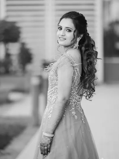 A classic black and white portrait of the bride looking over her shoulder. It's an elegant and timeless pose.
