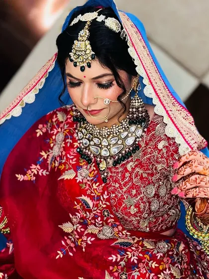 A closer look at the intricate details of her makeup and jewelry. The combination of the bindi, nose ring, and eye makeup is perfectly balanced.
