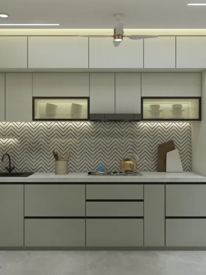 This kitchen features a mix of grey lower cabinets and white upper cabinets, creating a modern, two-tone effect. The glass-fronted cabinets add a touch of elegance.