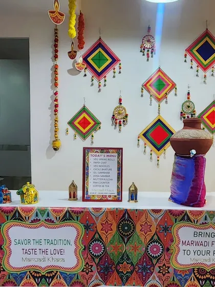 To complement a Marwadi-themed office celebration, I styled this food counter to perfection. The decor includes a colorful patterned table skirt, traditional Rajasthani wall hangings, and a decorated matka, creating an authentic and immersive experience for the employees.