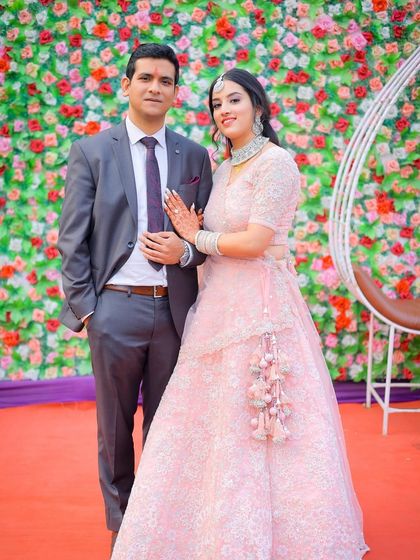 A classic couple portrait against a vibrant floral backdrop.
