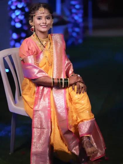 A beautiful portrait of a Maharashtrian bride in her yellow Nauvari, ready for her wedding ceremony.