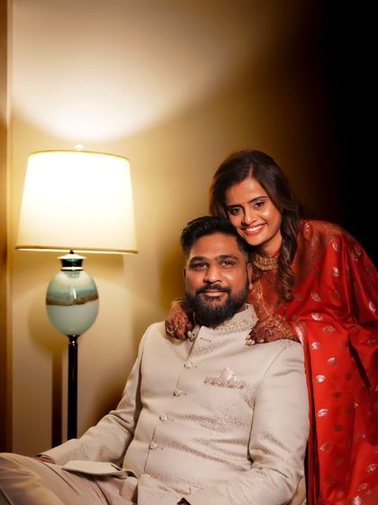 A happy and relaxed portrait of the couple at their reception, sharing a warm moment.