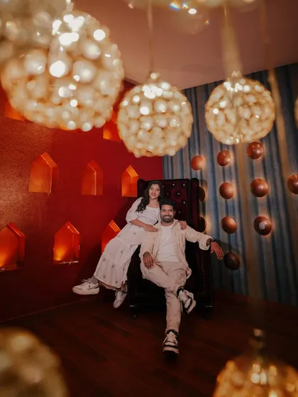 A cool and moody shot in our royal room, with unique hanging lamps and a throne-like chair creating a regal vibe.