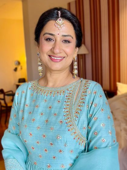 Her smile radiates pure happiness. The makeup is designed to enhance her natural beauty without feeling heavy, ensuring she feels comfortable and confident.