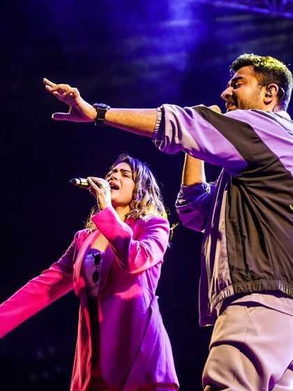 Sachin and Jigar performing together, showcasing the dynamic energy of their live shows. We book artists known for their incredible stage presence and crowd interaction.