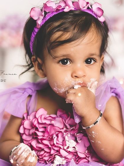 A close-up of a messy, happy face! This is what a successful first birthday cake smash looks like.