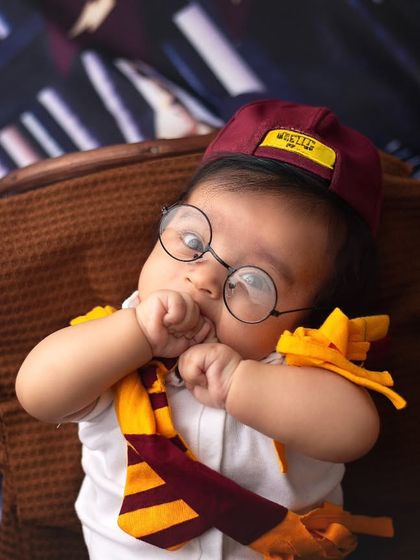 In love with this cute little Harry Potter. Even the tiniest wizards need a moment to think, and this little one is just too precious in his Gryffindor gear.