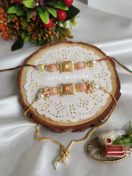 Another elegant couple's Rakhi set, this one in a lovely peach color with pearl details.
