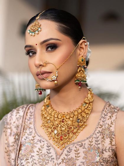 A stunning portrait of this bride. The soft smokey eye, flawless skin, and traditional gold jewelry create a look that is both powerful and elegant.