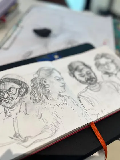 A page from my sketchbook featuring pencil caricatures of my artist friends, captured during one of our sketch walks.