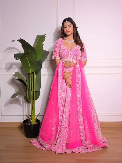 A full-length shot of the vibrant pink lehenga. This is an outfit that is guaranteed to make you stand out in the best way possible.