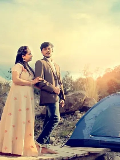 A pre-wedding shoot with a camping theme by the river, telling a story of adventure and love.
