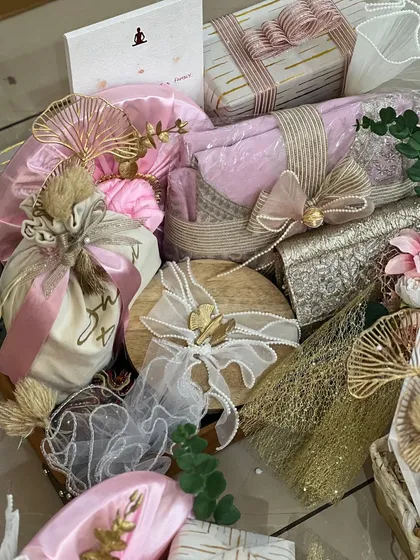 A close-up of a beautifully wrapped wedding hamper. I love playing with different textures and materials, like jute, net, and satin ribbons, to create a rich and layered look.