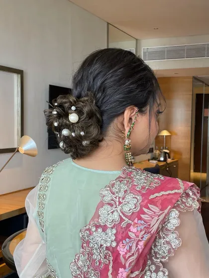 A side view of the dispersed pearl bun, highlighting the texture and placement of the pearls. This adds a touch of modern glamour to a classic updo.