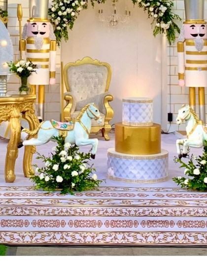The dessert area, featuring a multi-tiered cake and carousel horses, perfectly integrated into the royal theme.
