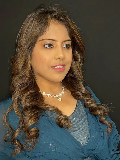 A beautiful party-ready look with soft, glamorous curls and a subtle hair color that catches the light perfectly. This hairstyle is elegant and perfect for any special occasion.