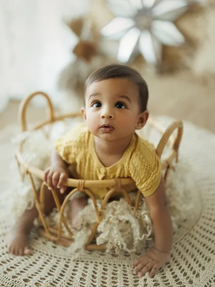 Full of curiosity and charm. This close-up from an 8-month session captures the inquisitive nature of babies at this age, always looking up and exploring the world.