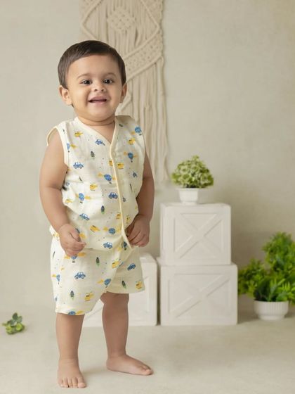 An adorable solo portrait of a little boy in our classic boho themed setup. The neutral tones and simple props keep the focus on his happy smile.