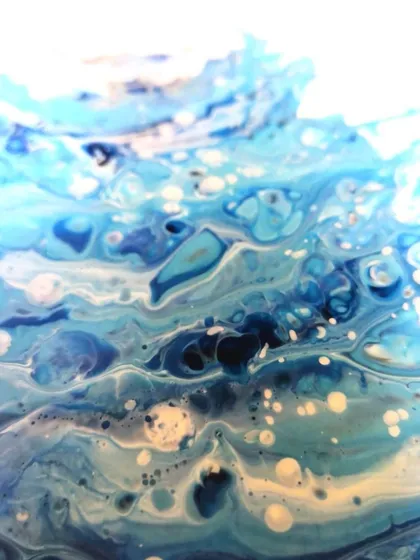 Another detail shot of the wave, focusing on the deeper blues and the bubbling texture of the foam. It feels like looking into the depths of the ocean.