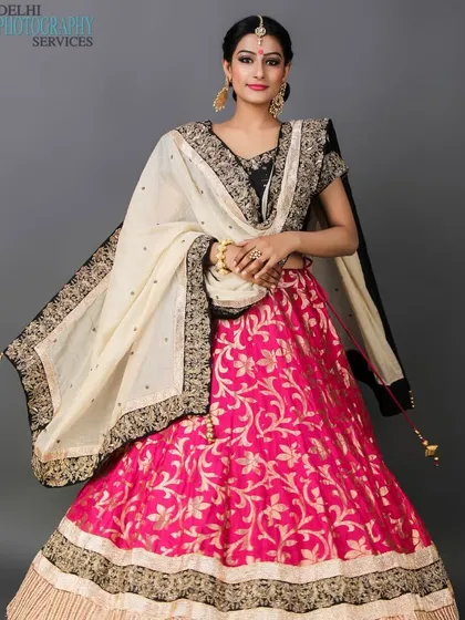 I create stunning portfolios for ethnic wear, capturing the richness of traditional Indian attire. This full-length shot features a model in a vibrant pink and black lehenga, showcasing the intricate details and flow of the garment for bridal or festive lookbooks.