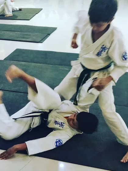 My self-defense seminars are designed to be practical for everyone. Here, two young students practice a takedown drill on a mat, learning how to control an opponent safely and effectively in a ground-based situation.