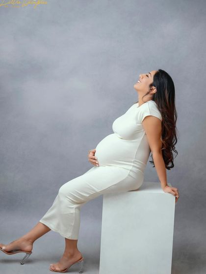 The pure joy of pregnancy captured in a classic portrait. This mom-to-be is absolutely glowing with happiness.