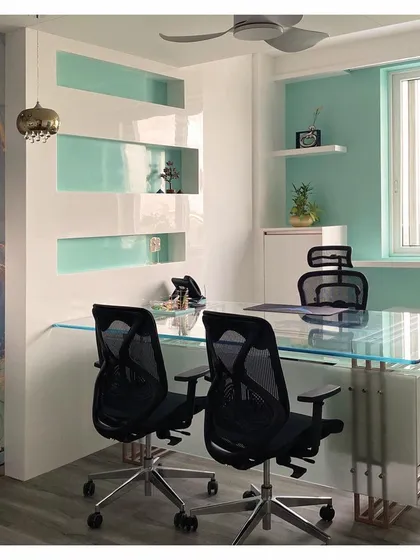 This image highlights the clean lines and reflective surfaces used in this cabin design. The combination of glass, high-gloss laminate, and a pop of color creates a modern and airy feel.