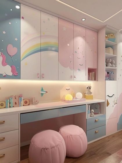 A shared study area for two in a unicorn-themed room. The long desk has ample space, with plenty of drawers and overhead cabinets decorated with rainbows and stars.