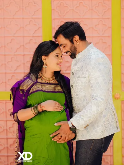 An intimate close-up of a couple, heads together, sharing a quiet moment during their traditional maternity session.