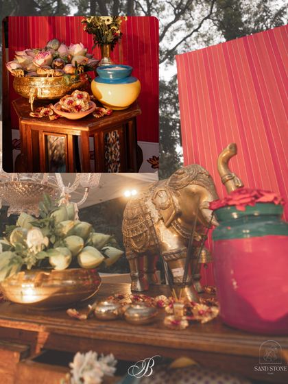 Details from the reception stage, where gleaming brass elephants and colorful jars filled with lotus buds are set against the rich, red fabric. This setup is a perfect example of sustainable decor that feels luxurious.