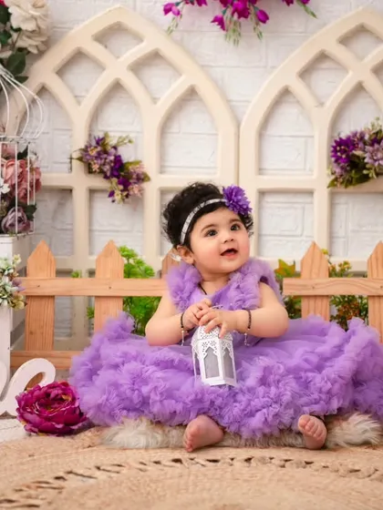 A princess in her purple garden. The intricate details of the set, from the birdcages to the variety of flowers, create a lush and luxurious scene.