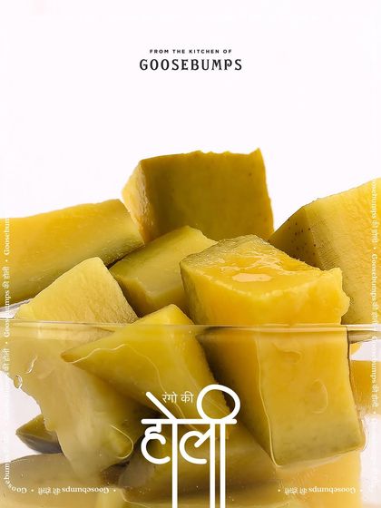 Chunks of peeled raw mango, their pale yellow a stark contrast to the vibrant spices they will soon meet.