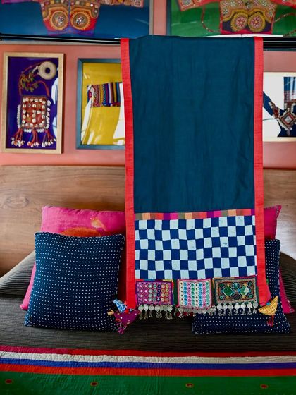 The full length of the pure linen throw, showcasing the striking border made from checkered fabric and vintage Lambani patches. This piece is a celebration of tribal craftsmanship.
