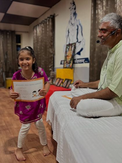 A young girl proudly holds up her graduation certificate. Our retreats are designed to be a week of fun, laughter, and positive experiences.